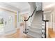 Bright foyer with hardwood floors and staircase, complemented by elegant trim at 1221 Tartarian Trl, Apex, NC 27502