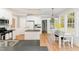 Spacious kitchen with white cabinets, stainless appliances, hardwood floors, and eat-in breakfast area at 1221 Tartarian Trl, Apex, NC 27502