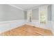 Bright living room featuring classic trim, hardwood floors, and natural light at 1221 Tartarian Trl, Apex, NC 27502
