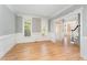 Bright living room featuring classic trim, hardwood floors, and natural light at 1221 Tartarian Trl, Apex, NC 27502