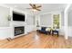 Cozy living room with a marble fireplace, hardwood floors, and natural light at 1221 Tartarian Trl, Apex, NC 27502
