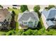 Birds eye view of a home featuring a gray roof, outdoor deck, and a backyard surrounded by mature trees at 12508 Angel Falls Rd, Raleigh, NC 27614