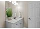 Bathroom features vanity with marble countertop, towel rack and decorative mirror at 12508 Angel Falls Rd, Raleigh, NC 27614