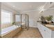 Well-appointed bathroom with a glass-enclosed shower, soaking tub, and dual vanity sinks at 12508 Angel Falls Rd, Raleigh, NC 27614