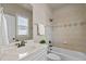 Bathroom features vanity with marble countertop, tiled shower and window at 12508 Angel Falls Rd, Raleigh, NC 27614