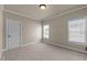 Neutral bedroom features carpet flooring, two windows and white trim at 12508 Angel Falls Rd, Raleigh, NC 27614