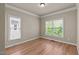 Cozy bedroom with hardwood floors and natural light from two bright sunny windows at 12508 Angel Falls Rd, Raleigh, NC 27614