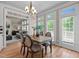 Sunlit dining room with hardwood floors, stylish chandelier, and access to outdoor patio at 12508 Angel Falls Rd, Raleigh, NC 27614