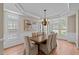 Dining area with modern decor, plantation shutters, hardwood floors, and a chandelier at 12508 Angel Falls Rd, Raleigh, NC 27614