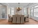 Elegant dining room with a chandelier, tray ceiling, and plantation shutters at 12508 Angel Falls Rd, Raleigh, NC 27614