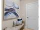 Inviting entryway with a cushioned bench, stylish pillows, and an eye-catching modern art piece at 12508 Angel Falls Rd, Raleigh, NC 27614