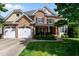 Charming brick home with a three-car garage and well-maintained landscaping in a suburban neighborhood at 12508 Angel Falls Rd, Raleigh, NC 27614