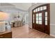 Spacious foyer with views of a dining room with a tray ceiling and a large front door at 12508 Angel Falls Rd, Raleigh, NC 27614