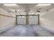 Clean two car garage with white doors, neutral walls, and concrete floors at 12508 Angel Falls Rd, Raleigh, NC 27614