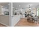 Open kitchen with white cabinets, stainless appliances, breakfast bar and adjacent dining area at 12508 Angel Falls Rd, Raleigh, NC 27614