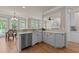 Open kitchen boasts modern stainless steel appliances, quartz countertops and breakfast area at 12508 Angel Falls Rd, Raleigh, NC 27614