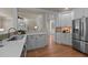 Bright kitchen featuring stainless steel appliances, white cabinetry and an open floor plan at 12508 Angel Falls Rd, Raleigh, NC 27614