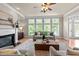 Spacious living room boasts natural light, fireplace, and comfortable seating arrangement at 12508 Angel Falls Rd, Raleigh, NC 27614