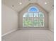 Bright living room with vaulted ceilings and large arched windows offering abundant natural light at 12508 Angel Falls Rd, Raleigh, NC 27614