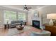 Bright living room with fireplace, large windows, hardwood floors and neutral decor at 12508 Angel Falls Rd, Raleigh, NC 27614