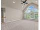 Large, light-filled living room features a vaulted ceiling, ceiling fan, and large, arched windows at 12508 Angel Falls Rd, Raleigh, NC 27614