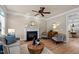Cozy living room featuring a decorative fireplace, wooden flooring and comfortable seating at 12508 Angel Falls Rd, Raleigh, NC 27614