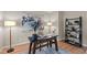 Modern office featuring a dark wood desk, stylish decor, and ample lighting at 12508 Angel Falls Rd, Raleigh, NC 27614