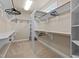 Spacious walk-in closet features carpeted floor, white shelves and wooden closet rods at 12508 Angel Falls Rd, Raleigh, NC 27614