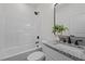 Bathroom featuring modern fixtures, granite countertop, and shower-tub combo at 1303 Whitsett St, Burlington, NC 27217