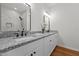 Modern bathroom features dual sinks, granite countertops, and a separate glass enclosed shower at 1303 Whitsett St, Burlington, NC 27217