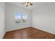 Clean bedroom with hardwood flooring, bright double windows, and new ceiling fan at 1303 Whitsett St, Burlington, NC 27217