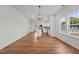 Open dining area showing access to kitchen with center island, stainless appliances, and large picture window at 1303 Whitsett St, Burlington, NC 27217