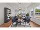 A modern dining room is shown with seating for eight, sleek lighting and direct access to the kitchen at 1303 Whitsett St, Burlington, NC 27217