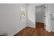 Entryway featuring hardwood floors, a glass-paneled door, and a view to another room at 1303 Whitsett St, Burlington, NC 27217