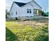 A charming home with white siding and a lovely porch, perfect for enjoying the outdoors at 1303 Whitsett St, Burlington, NC 27217