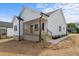 Charming single-Gathering home showcasing white siding and a welcoming front porch at 1303 Whitsett St, Burlington, NC 27217