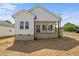 Beautiful home featuring white siding, a covered porch, and meticulously maintained landscaping at 1303 Whitsett St, Burlington, NC 27217