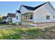 Charming home featuring white siding, a covered porch, and a well-maintained lawn at 1303 Whitsett St, Burlington, NC 27217