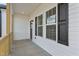 Cozy front porch featuring natural wood accents and classic white siding for a welcoming appeal at 1303 Whitsett St, Burlington, NC 27217