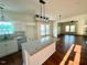 Open-concept kitchen with a large island, modern lighting, and hardwood floors throughout at 1303 Whitsett St, Burlington, NC 27217