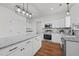 Bright open kitchen with stainless appliances, granite counters, and white cabinets at 1303 Whitsett St, Burlington, NC 27217