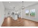 Open concept kitchen with modern lighting, a center island with granite counters, and stainless appliances at 1303 Whitsett St, Burlington, NC 27217