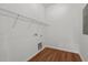 Simple laundry room with wire shelving, hardwood floors, and new drywall at 1303 Whitsett St, Burlington, NC 27217