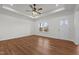Bright living room with tray ceilings, wood-look flooring, large windows, and a front door at 1303 Whitsett St, Burlington, NC 27217