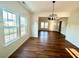 Bright living room with hardwood floors and large windows providing plenty of natural light at 1303 Whitsett St, Burlington, NC 27217