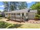 Back of the house with a deck, landscaped garden beds, and a lush green lawn at 1314 Hudson Ave, Durham, NC 27705