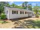 Rear exterior of a well-maintained home with a lush lawn and mature landscaping at 1314 Hudson Ave, Durham, NC 27705