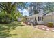 Backyard view featuring a well-maintained lawn, mature trees, and a charming storage shed at 1314 Hudson Ave, Durham, NC 27705