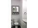 Bathroom with gray vanity, mirror cabinet, toilet, and pedestal sink at 1314 Hudson Ave, Durham, NC 27705