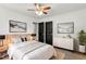 Spacious bedroom with ceiling fan, light wood furniture, and modern artwork at 1314 Hudson Ave, Durham, NC 27705